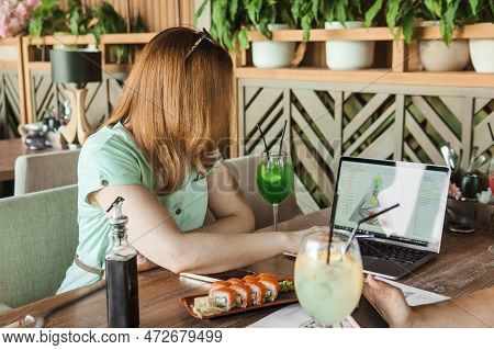 Tver, Russia-august 7, 2022. A Woman With A Laptop Is Studying Human Design. The Concept Of Studying