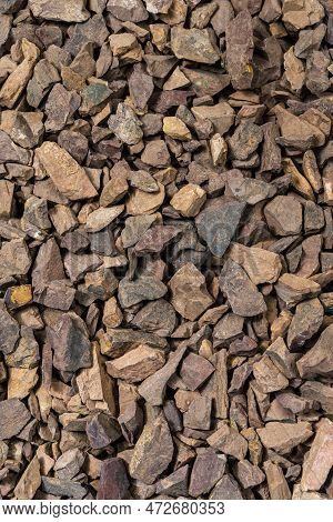 Closeup Image Of Background Made Of Pile Of Colorful Brown, Yellow And Red Crushed Stones.