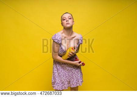 Young Classic Pin-up Woman Painting Wall With Paint Roller