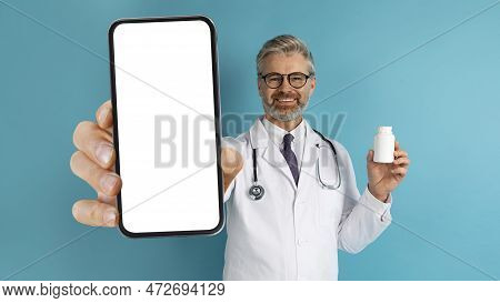 Happy European Doc Showing Phone And Medicine