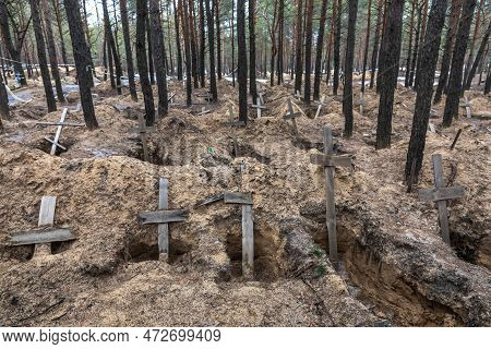 Izium, Ukraine - Mar. 03, 2023: Crosses Are Seen At A Forest Grave Site After An Exhumation In The T