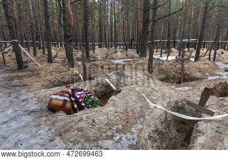 Izium, Ukraine - Mar. 03, 2023: Some Of The Victims Were Buried In Coffins With Flower Arrangements 