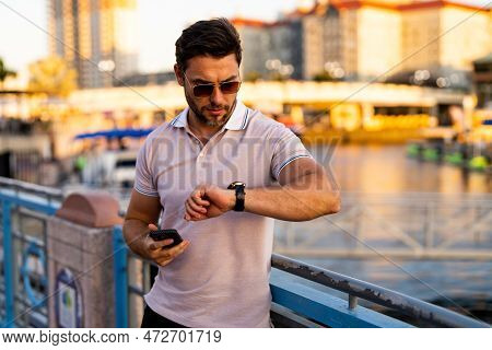 Portrait Of Handsome Confident Stylish Man In Big City. Sexy Man In Casual Clothes Posing On The Str