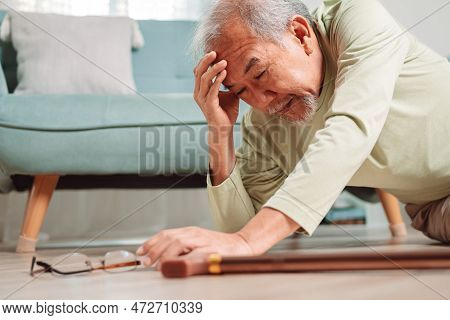 Asian Senior Man Falling On The Ground With Walker In Living Room At Home. Elderly Older Mature Male
