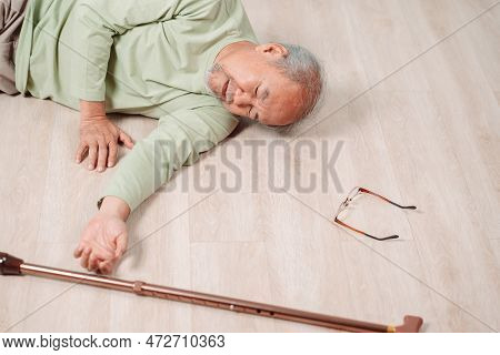 Asian Senior Man Falling On The Ground With Walker In Living Room At Home. Elderly Older Mature Male
