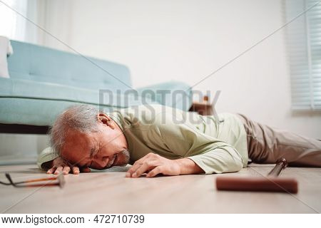 Asian Senior Man Falling On The Ground With Walker In Living Room At Home. Elderly Older Mature Male