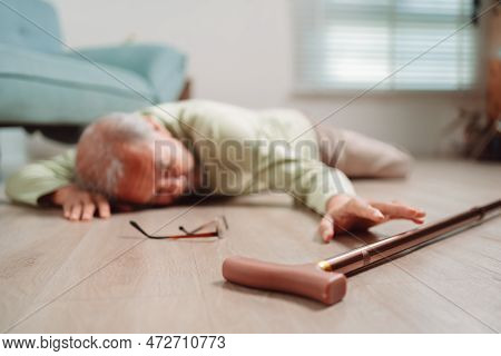 Asian Senior Man Falling On The Ground With Walker In Living Room At Home. Elderly Older Mature Male