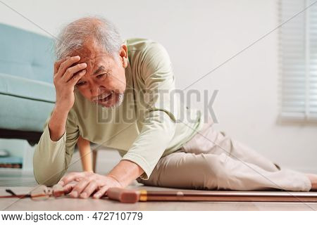 Asian Senior Man Falling On The Ground With Walker In Living Room At Home. Elderly Older Mature Male