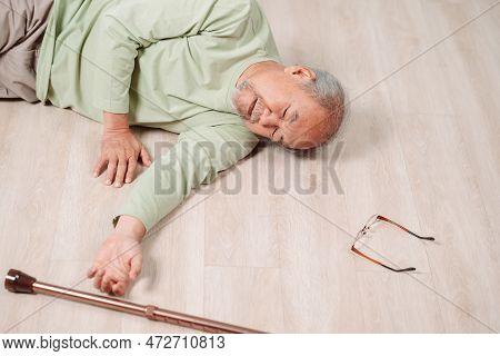 Asian Senior Man Falling On The Ground With Walker In Living Room At Home. Elderly Older Mature Male