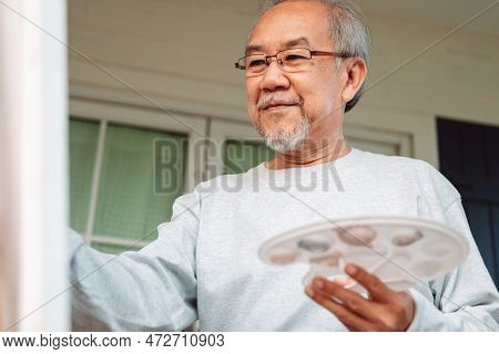 Asian Caregiver Helping Senior Male From Falling On The Ground. Older Elderly Man Patient Having Acc