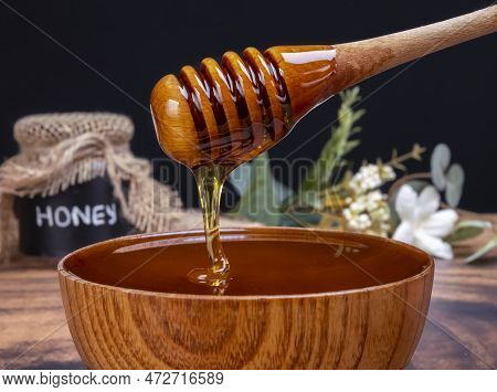 Honey Spoon Coming Out Of The Bowl Full Of Honey. Honey Contains Many Nutrients, Antioxidants, Impro