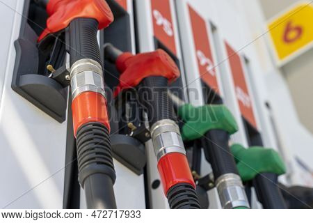 Refueling Pistols Hang In A Row At A Gas Station. Side View From Below