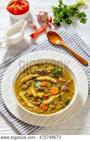 Gungo Peas, Pigeon Peas Soup With Dumplings , Vegetables And Beef In White Bowl On White Table, Jama