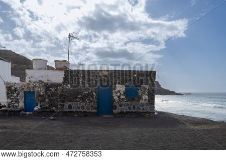 Hosue Made Of Stones With Details In Deep Blue Color, Built Directly And The Coastline Of The Atlant