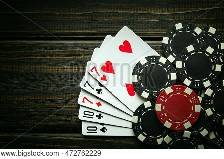 Playing Poker With A Winning Combination Of Full House Or Full Boat. Cards With Chips On A Black Vin