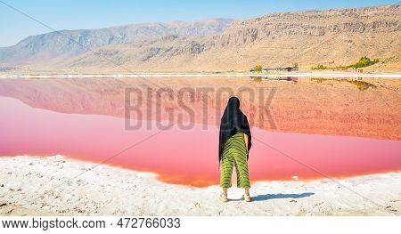 Caucasian Woman Tourist Stand On Maharlu Pink Salt Lake Shore. Travel Destination Iran In Shiraz