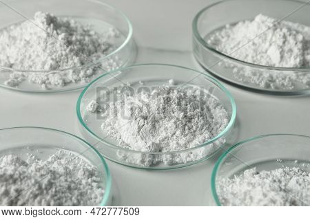 Petri Dishes With Calcium Carbonate Powder On White Marble Table, Closeup