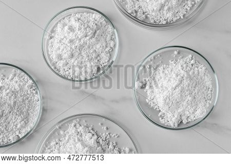 Many Petri Dishes With Calcium Carbonate Powder On White Marble Table, Flat Lay