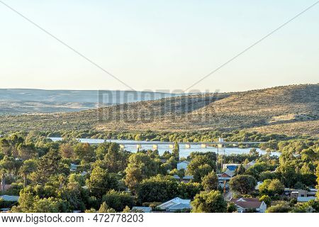 Prieska, South Africa - Feb 28 2023: The Road Bridge Over The Flooded Orange River Is Visible Over P