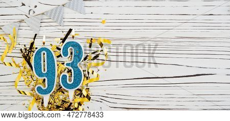 Number 93 Blue Celebration Candle On White Wooden Background. Happy Birthday For Ninety-three Years 