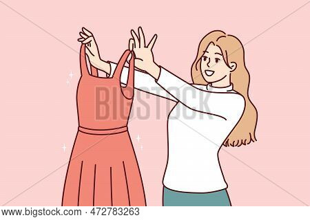 Woman Examines Beautiful Evening Dress Choosing Outfit For Going To Ball Or Festive Party. Girl Shop