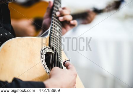 Close Up Of The Guitar Of A Man Playing Traditional Portuguese  Fado
