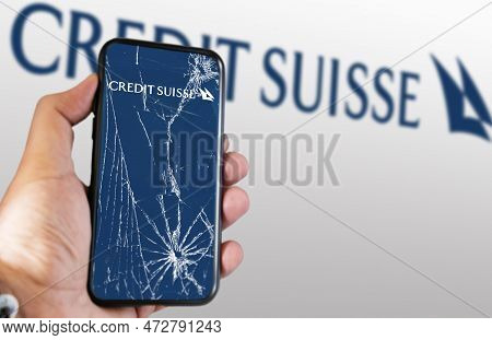 New York, Us, March 2023: Hand Holding A Phone With The Credit Suisse Logo On The Cracked Screen. In