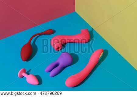 Many Adult Sex Toys Such As Dildo, Vibrator, Buttplug On Colored Background. Sex Shop Concept