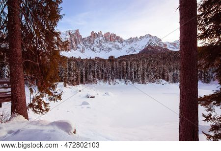 Panoramic View Of Snow Covered Lake Carezza And Latemar In Winter