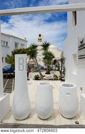 Fira, Greece - May 17: The View On Fira Town And Tourists Enjoying Their Vacation On May 17, 2014 In