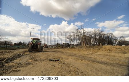 Major Construction Of Road Infrastructure . Under The Blue Sky With Clouds. A Thoroughly Dug Up Stre