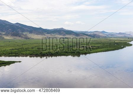 Landscape Of A Beautiful Large Selenga River Against The Background Of Mountains, Steppe And Blue Cl