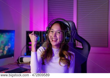 Asian Gamer Playing Online Video Game Winning Excited On Pc With Lighting Effect, Broadcast Streamin