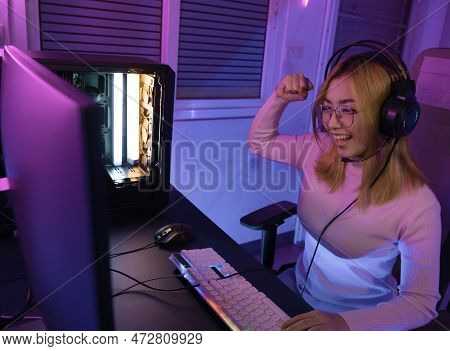 A Professional female pro gamer play online video games cyber sport and esport winner emotion. Young