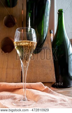 Glass Of Sparkling White Wine Champagne Or Cava With Bubbles And Classic Wooden Champagne Pupitre Ra