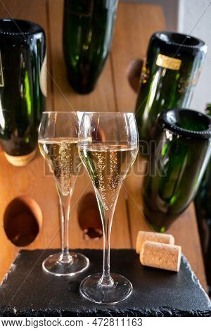 Glasses Of Sparkling White Wine Champagne Or Cava With Bubbles And Classic Wooden Champagne Pupitre