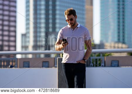 Young Handsome Man In Classik Polo T-shirt On The Street. Handsome Confident Stylish Hipster Model P