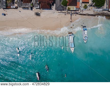 Aerial Shoreline View Of Jungutbatu Beach At Nusa Lembongan With Tourist Speedboat Anchored. One Of 