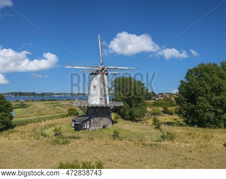 Aerial View With The Windmill De Koe In Veere. In The Background The Inland Water Veerse Meer. Veere