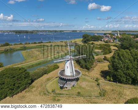 Aerial View With The Windmill De Koe In Veere. In The Background The Inland Water Veerse Meer And Ci