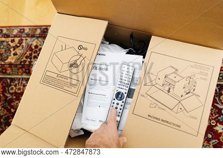 Frankfurt, Germany - Feb 23, 2023: Pov Male Hand Unboxing Unpacking New Onkyo Cardboard Of A Video A