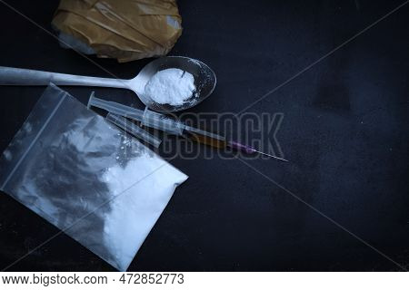 Heroin Liquid And Heroin Powder On A Black Background, Concept Of A Narcotic Substance