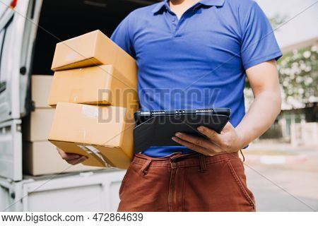 Delivery Man With Protective Mask And Gloves Delivering Parcels During Lockdown And Pandemic And Hol