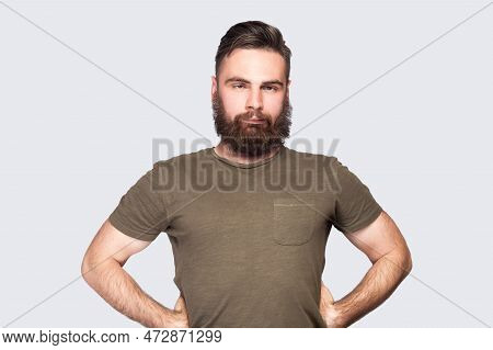 Portrait Of Bearded Man Wearing Dark Green T-shirt Looking Cross-eyed With Stupid Facial Expression,
