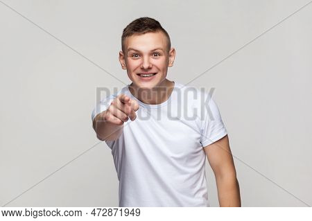 Portrait Of Astonished Surprised Young Teenager Boy Wearing T-shirt Looking At Camera With Big Eyes,