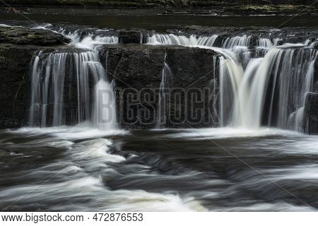 Beautiful Peaceful Landscape Image Of Aysgarth Falls In Yorkshire Dales In England During Winter Mor