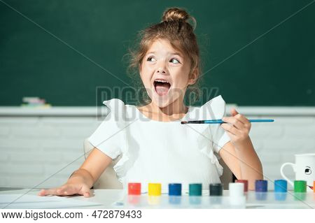 Child Girl Drawing With Coloring Pens Paintind. Portrait Of Adorable Little Girl Smiling Happily Whi