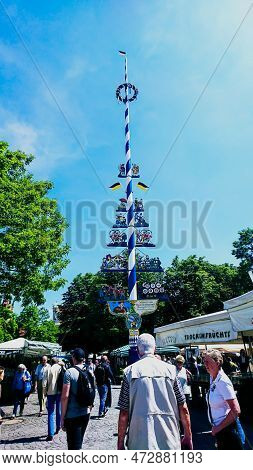 Viktualienmarkt, Munich, Germany - June 15, 2018: Maypole Under Sunlight And Blue Sky In Viktualienm