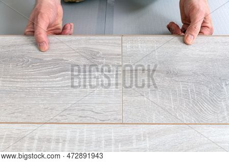 Man Lays Laminate On The Floor, Butt-joining The Boards. Repair And Decoration Of Premises. Modern F
