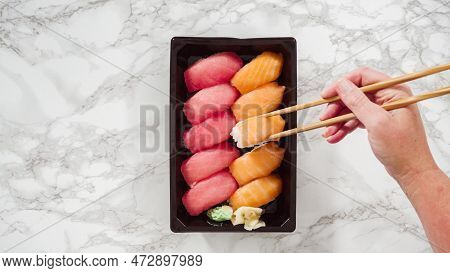 Flat Lay. Pre-packaged Variety Of Sushi And Sushi Rolls In A Plastic Tray.